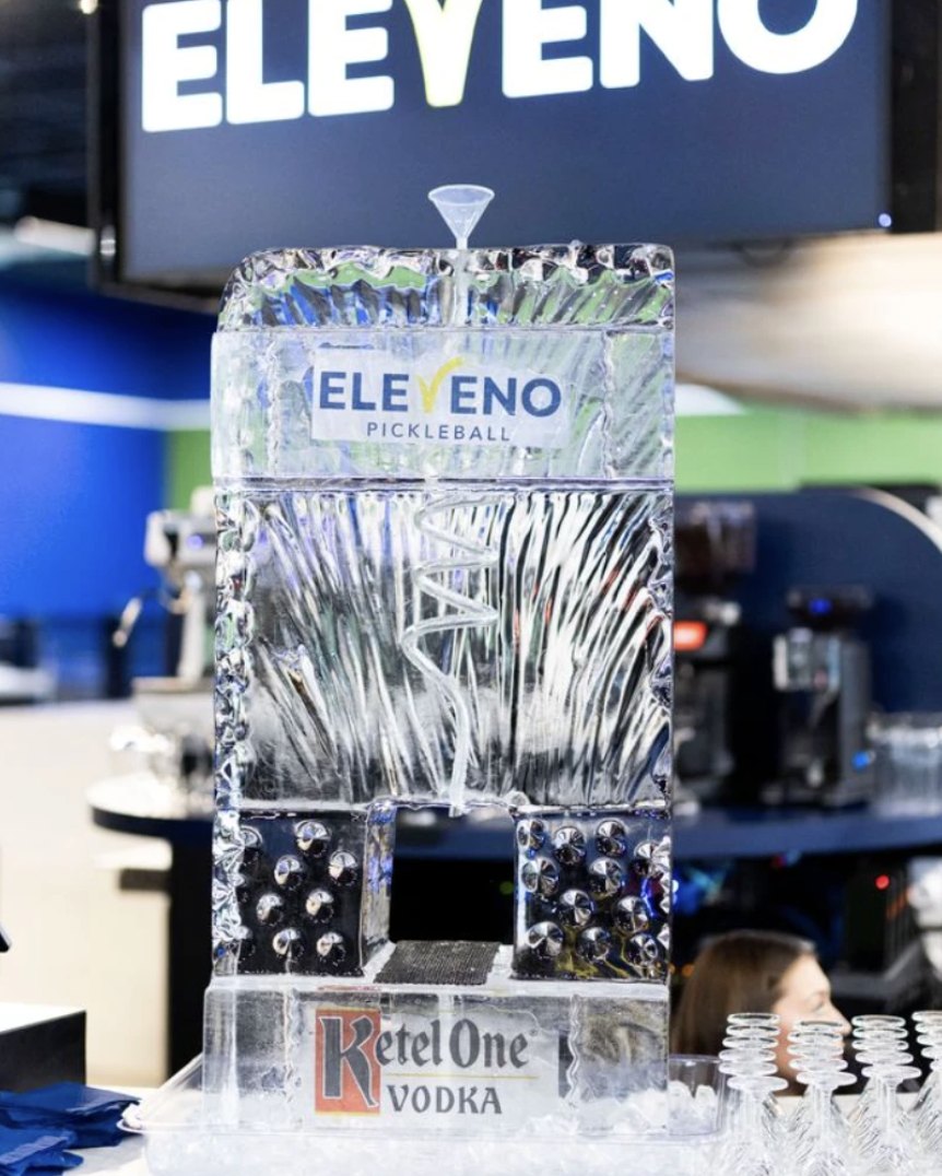 An ELEVENO-branded ice luge on the bar, set up for service
