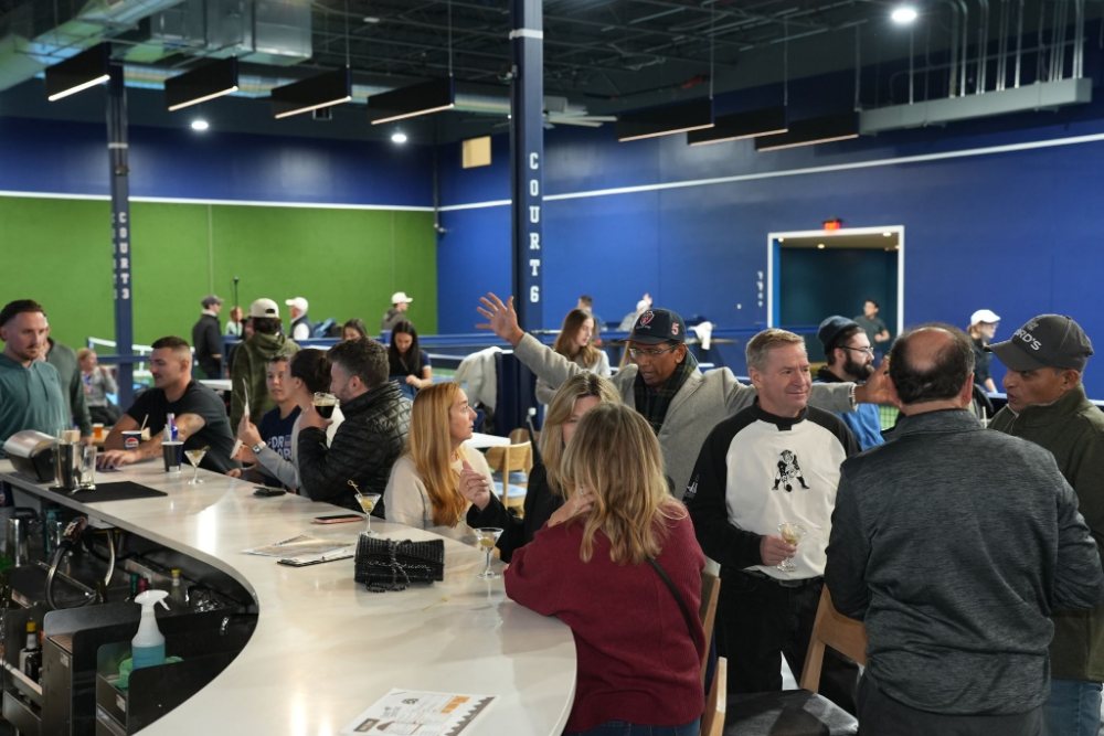 Guests talking around the bar at a networking evening