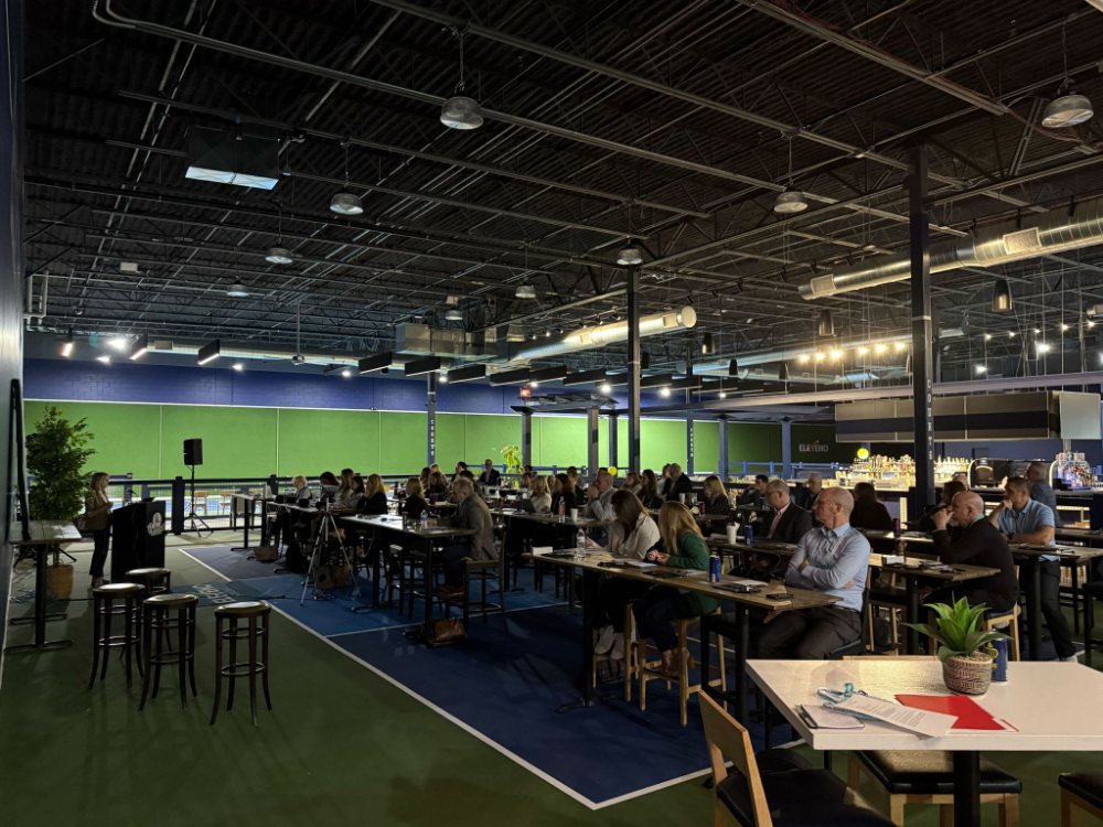 Banquet tables laid out across a court for a corporate offsite