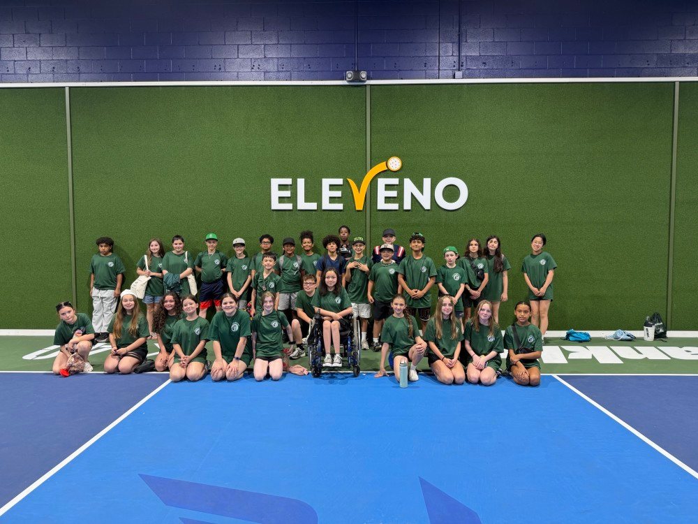 A school team lined up on court in matching kit